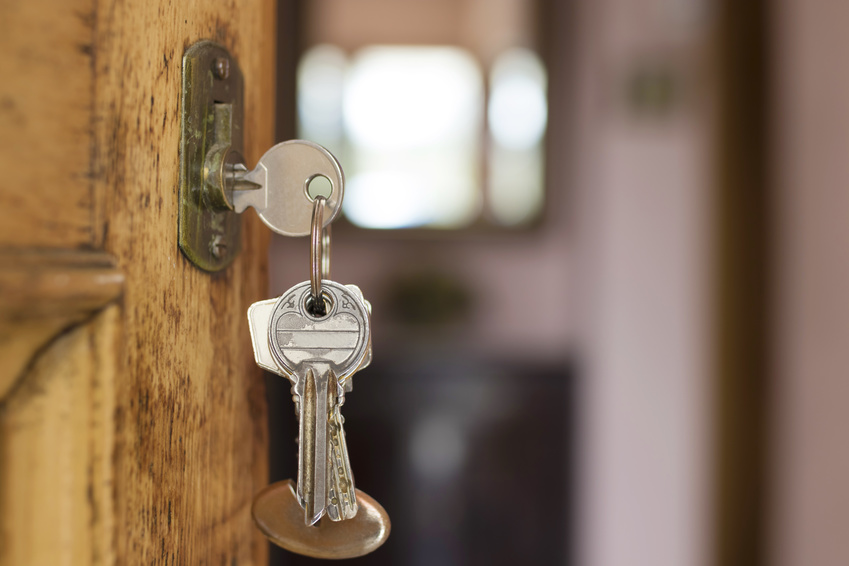 Keys in the lock of a wooden front door