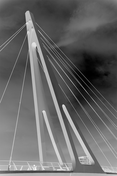 Black and white view looking up the mast and cables of a Clyde bridge