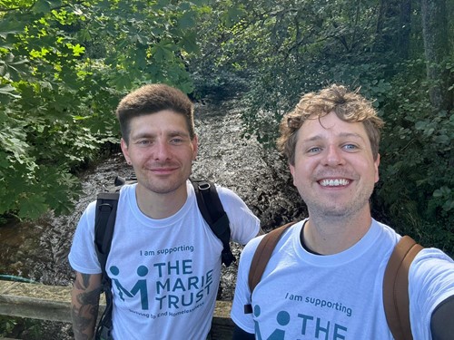 Two supporters wearing Marie Trust t-shirts on a charity walk