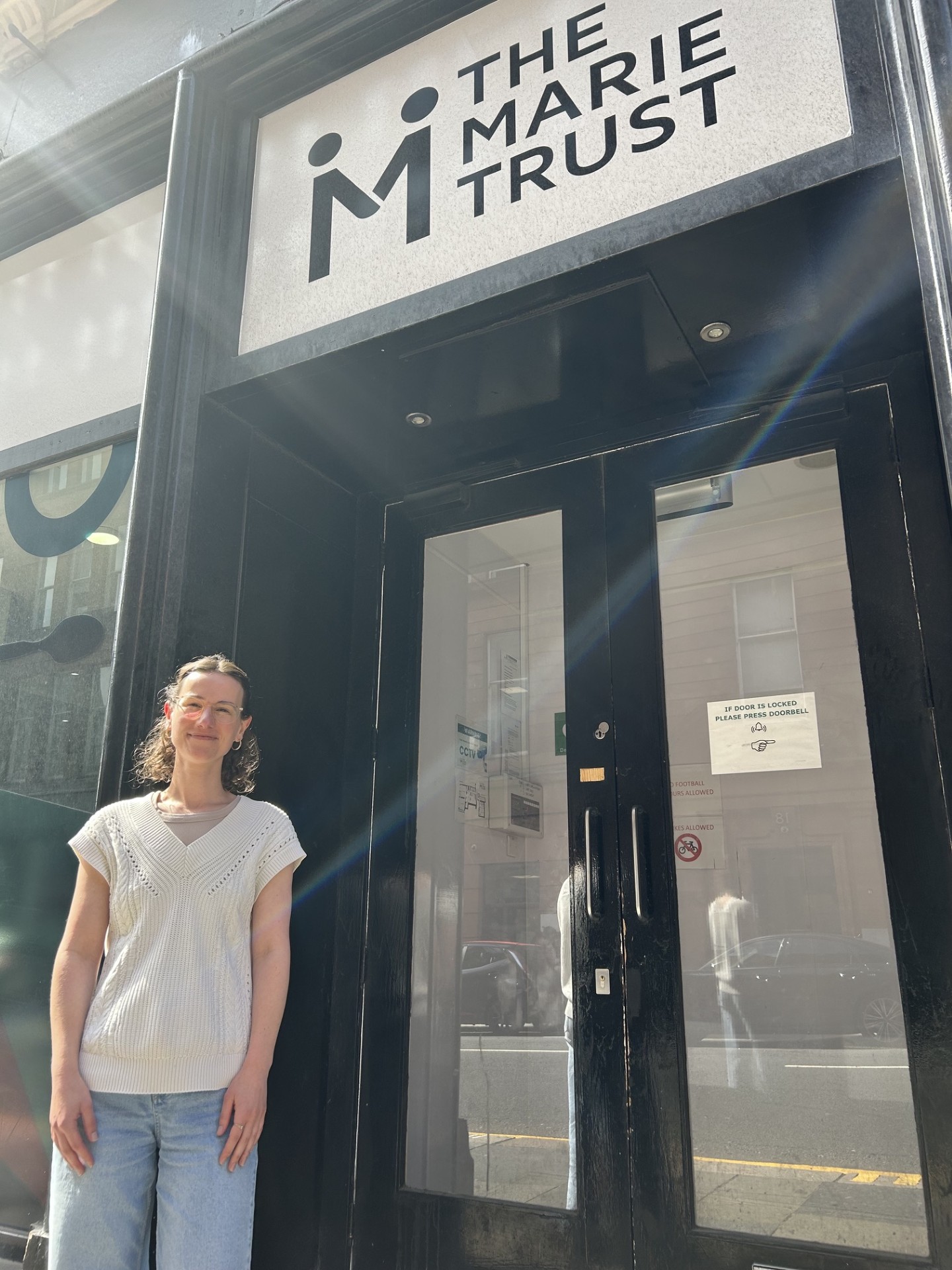Valérie Stevens standing outside The Marie Trust's Albion Street entrance in Glasgow