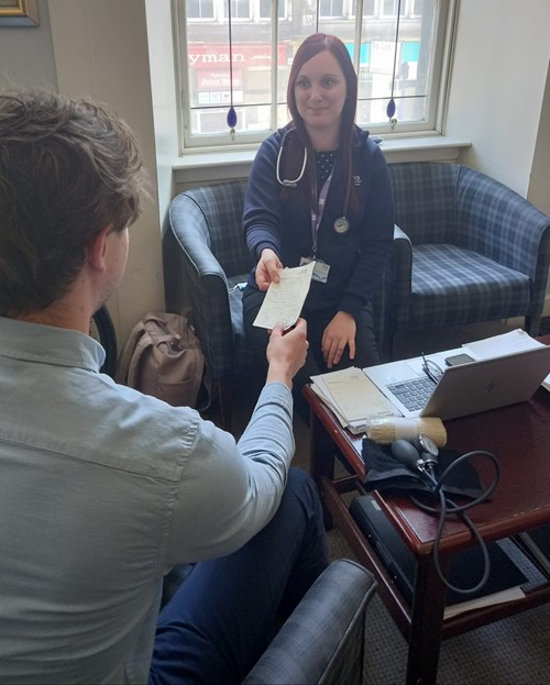 A hospital outreach worker speaking with a patient
