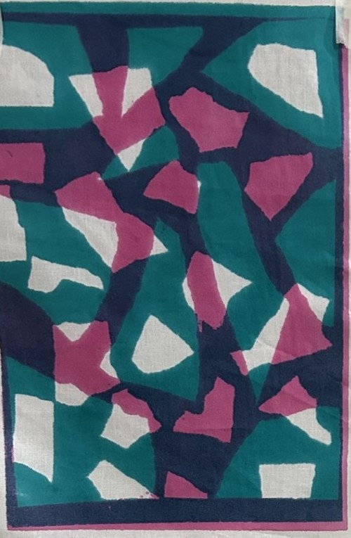 Printed fabric of teal, navy, pink and cream mosaic shapes