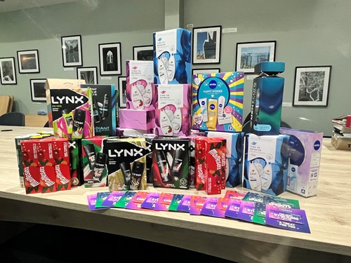 Donated toiletries, gift sets and cards laid out on a table