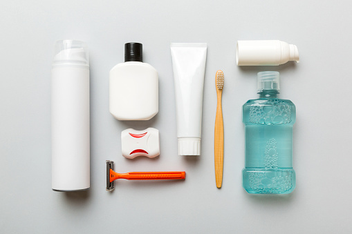 Everyday toiletries laid out neatly including toothbrush, razor and mouthwash