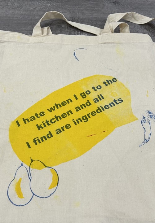 Canvas tote bag printed with a yellow speech bubble reading 'I hate when I go to the kitchen and all I find are ingredients'